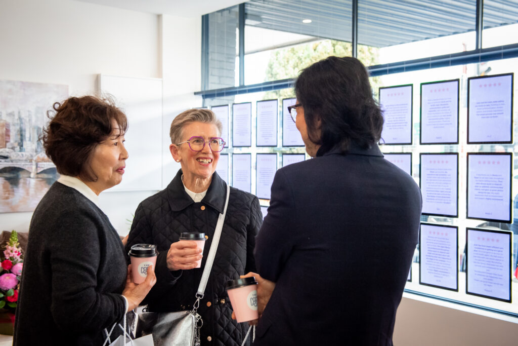 Guests chatting inside the Scott Kim Real Estate office